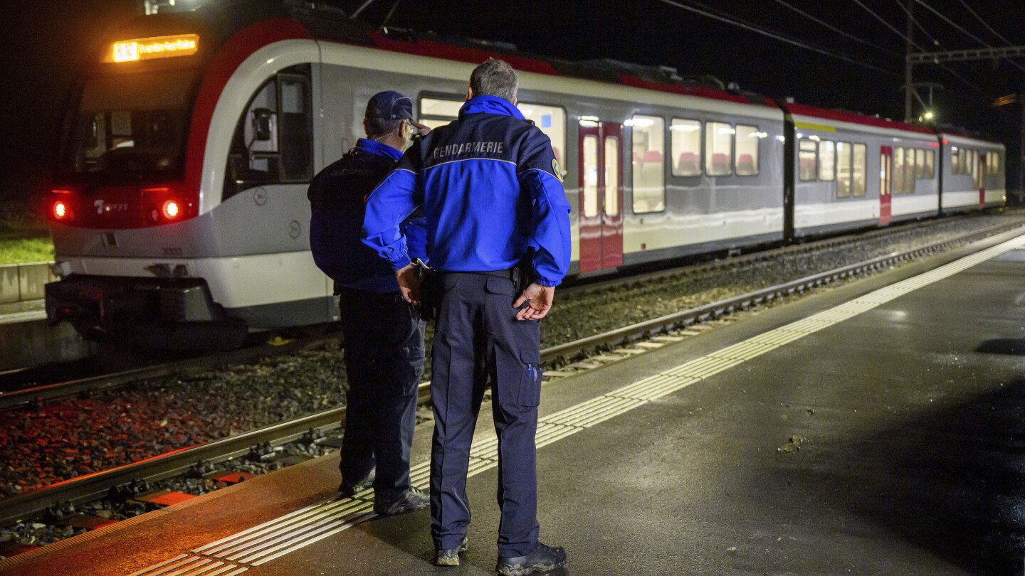 Iranian man wielding an axe and knife is killed by police after seizing hostages on Swiss train