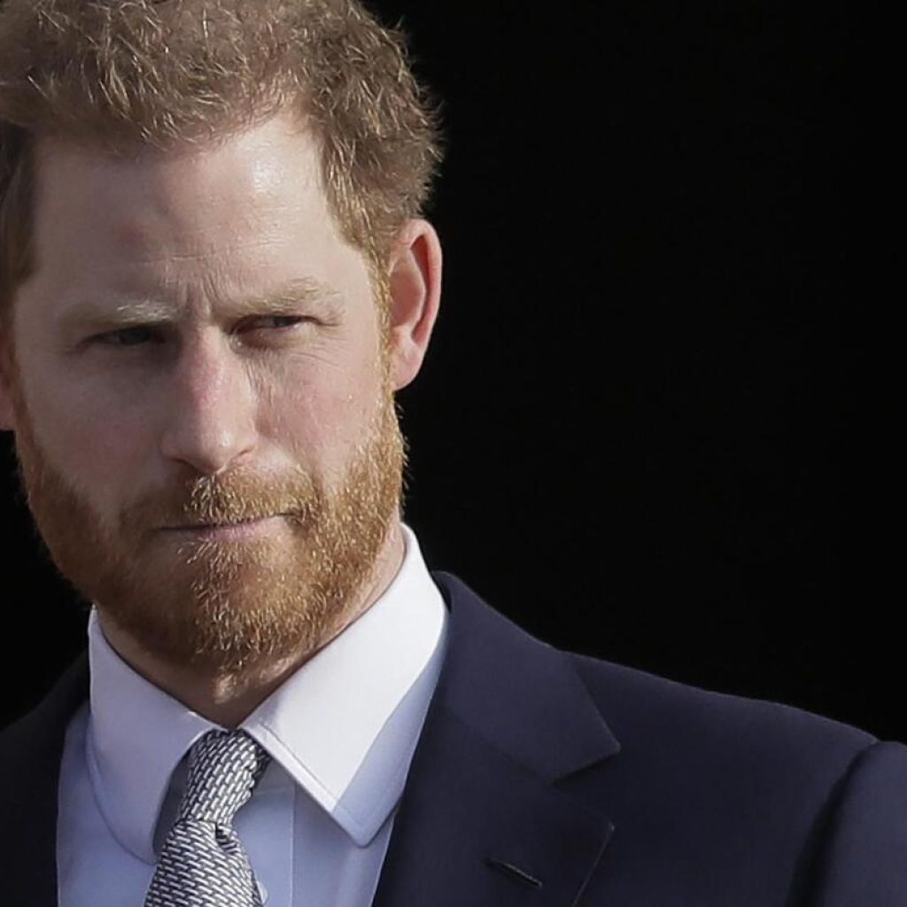 Prince Harry settles a tabloid phone hacking claim and says his mission to tame the media continues