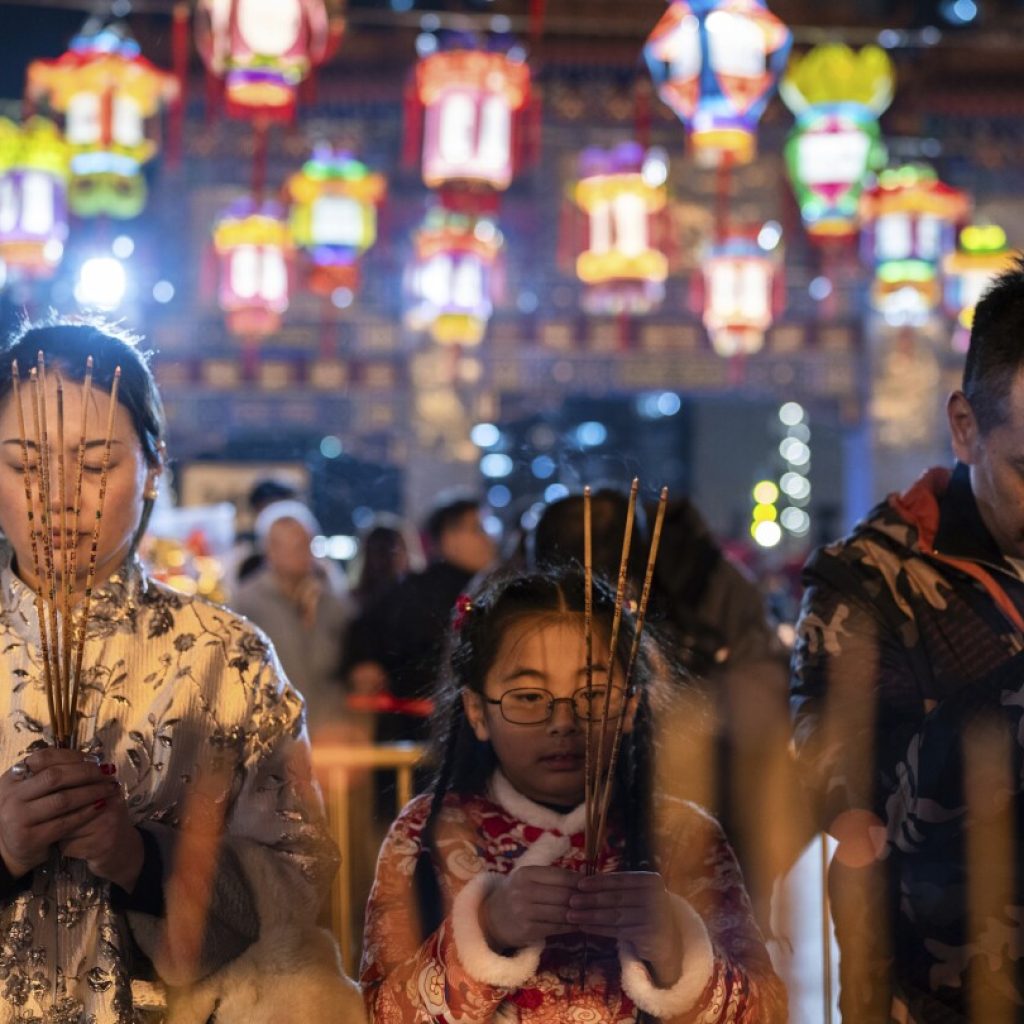 AP PHOTOS: Asia welcomes Lunar New Year of the Dragon with temple visits and celebrations