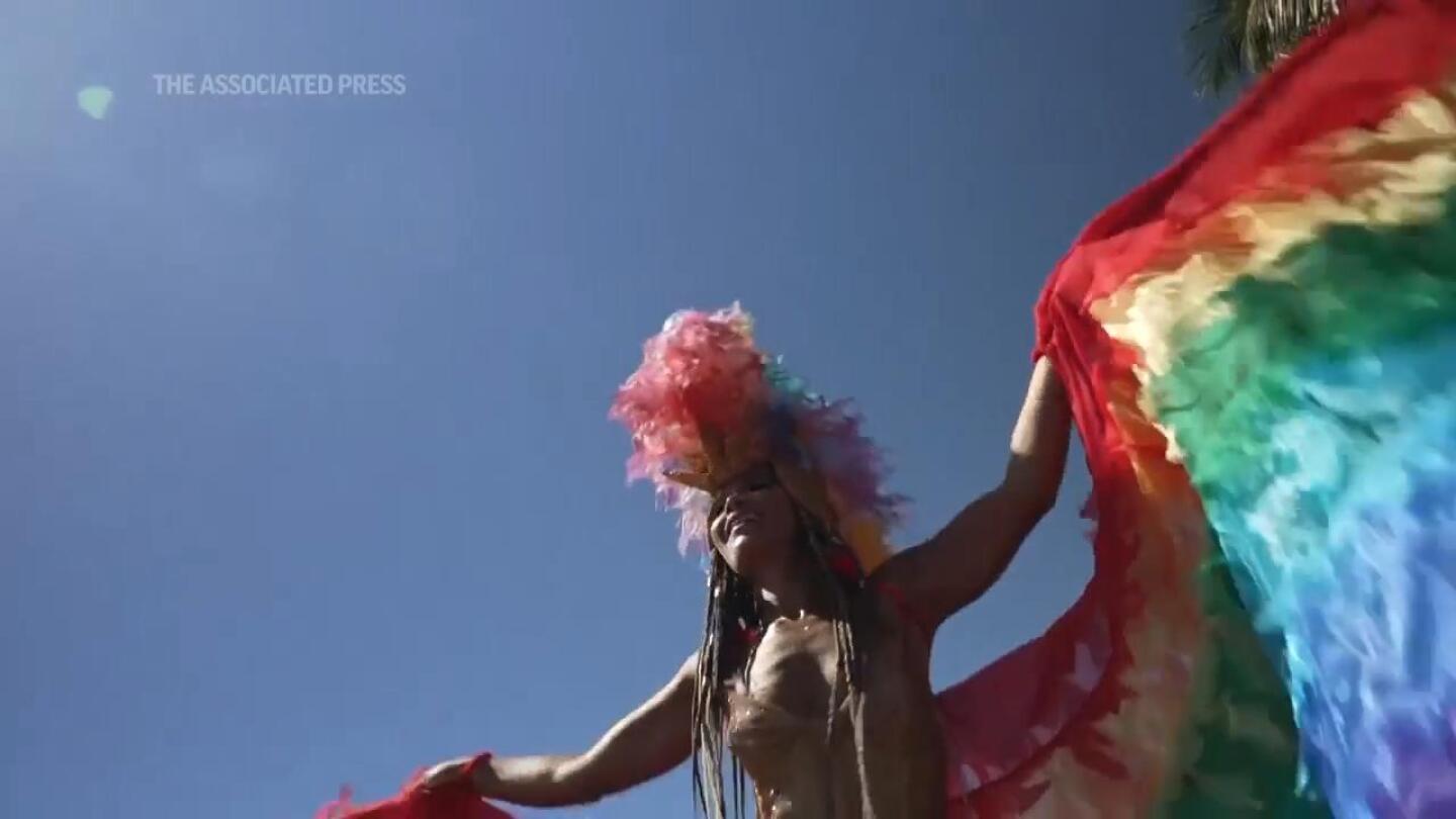 Stilt artist brightens Rio’s street carnival | AP News