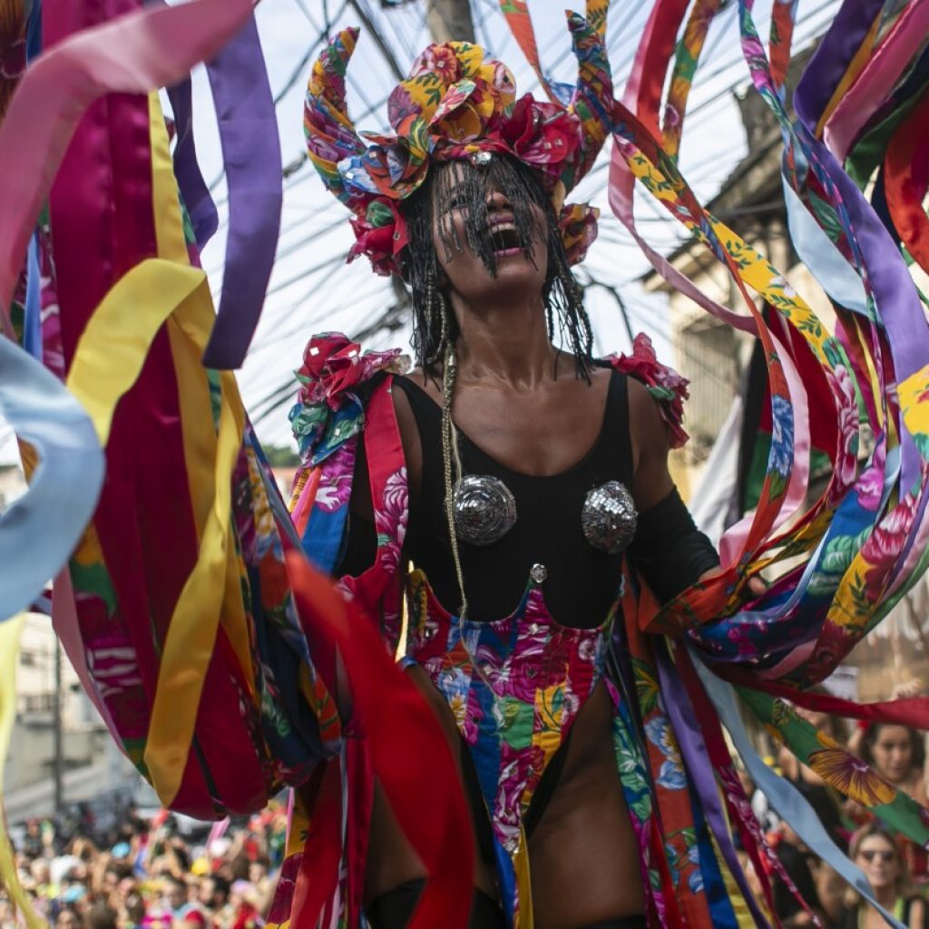 AP PHOTOS: A Carnival day in Brazil, from a morning street party to an evening samba parade