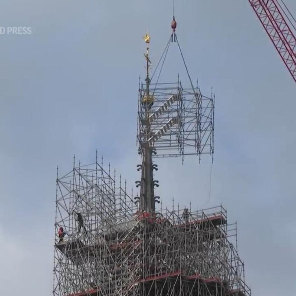 Removal of scaffolding enshrouding the summit of Paris’ Notre Dame Cathedral gets underway | AP News