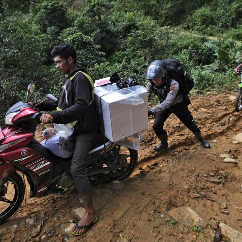 Election ballots and boxes carried across Indonesia by motorcycle, boat, horse and on foot