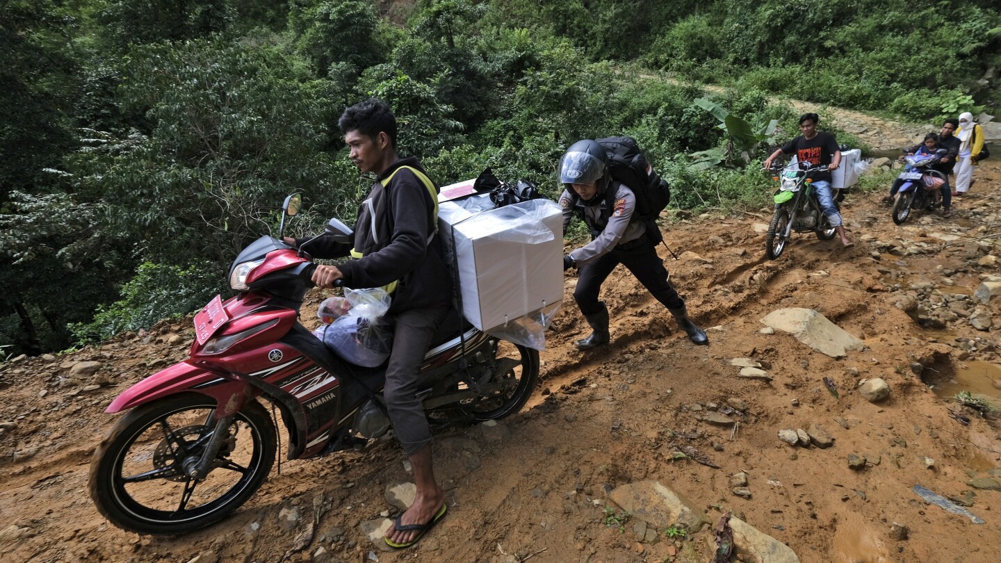 Election ballots and boxes carried across Indonesia by motorcycle, boat, horse and on foot