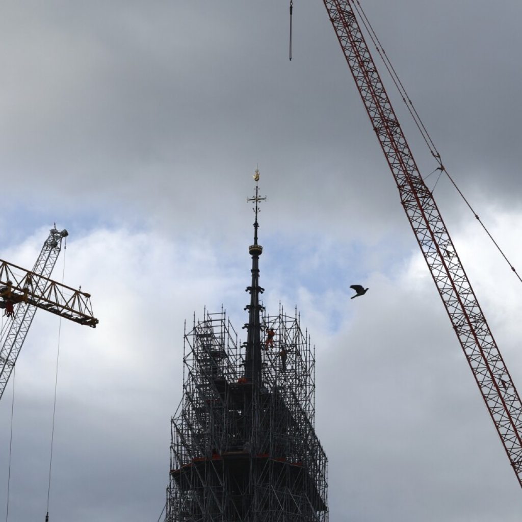 Notre Dame cathedral’s spire revealed in Paris as reconstruction continues after fire