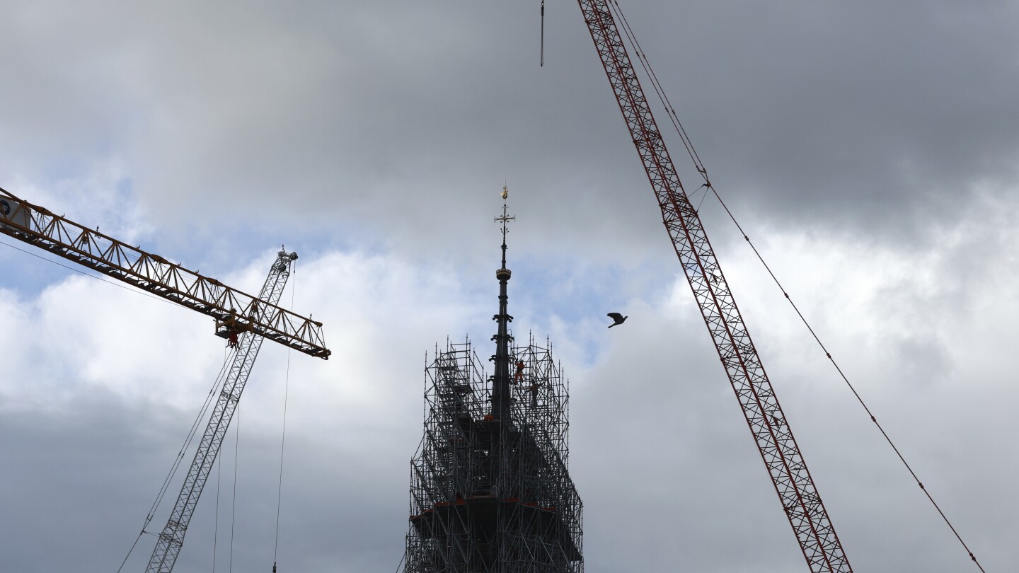 Notre Dame cathedral’s spire revealed in Paris as reconstruction continues after fire