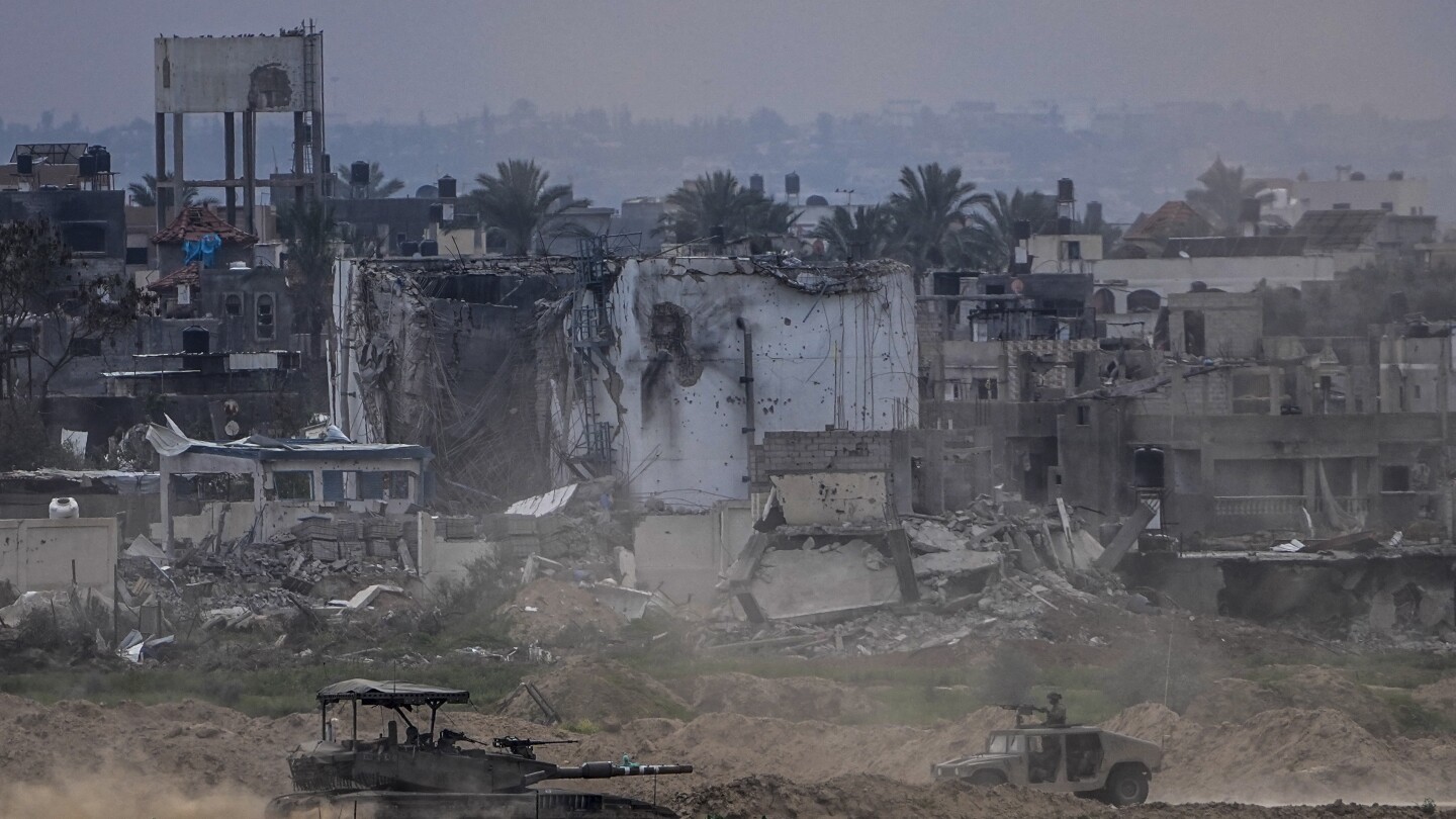 Displaced Palestinians leave one of Gaza’s main hospitals after weeks of being isolated by fighting