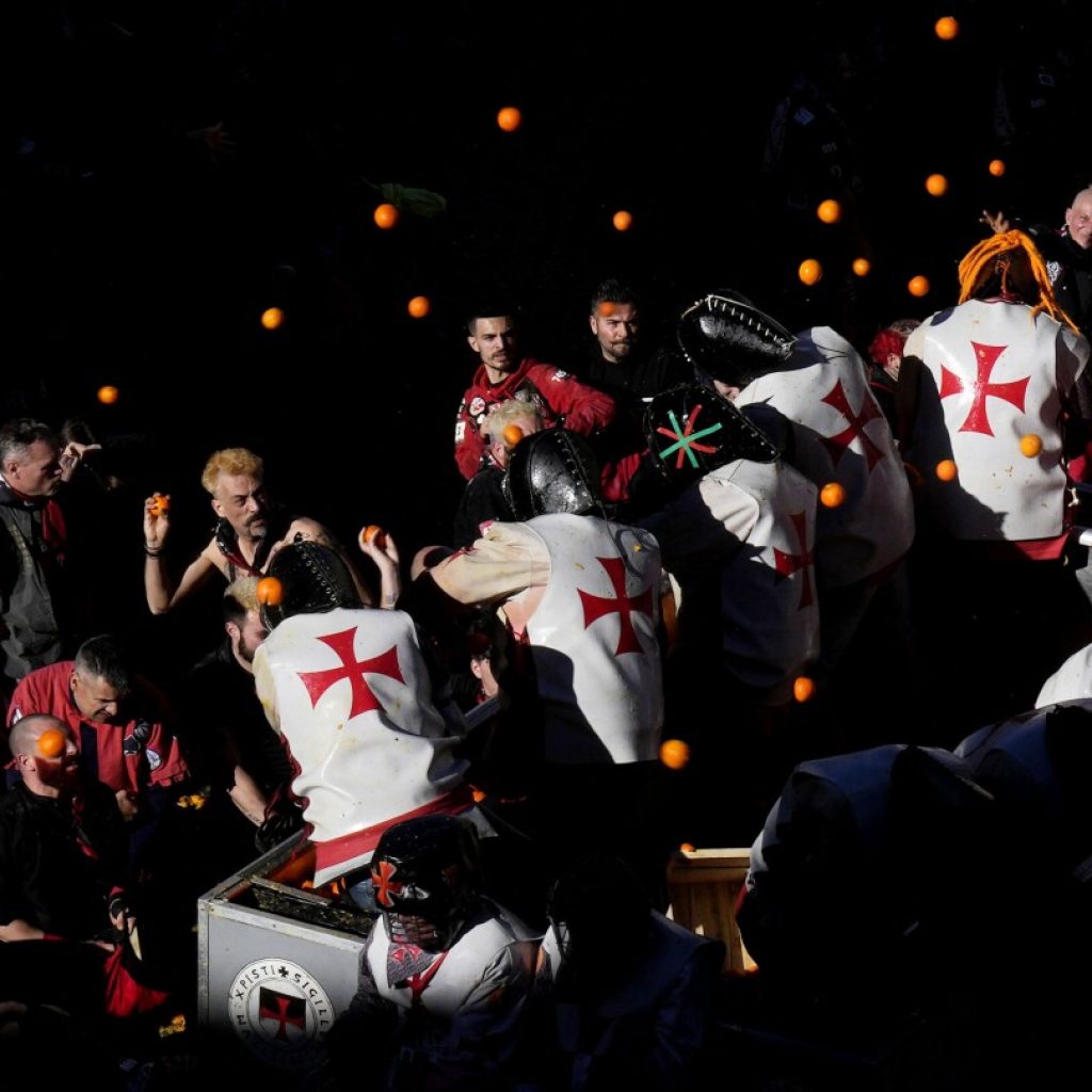 AP PHOTOS: Pulp flies in traditional orange battle during Carnival in northern Italy