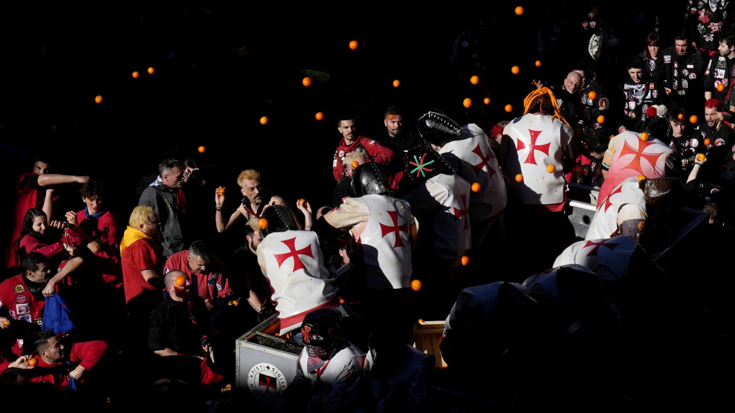 AP PHOTOS: Pulp flies in traditional orange battle during Carnival in northern Italy