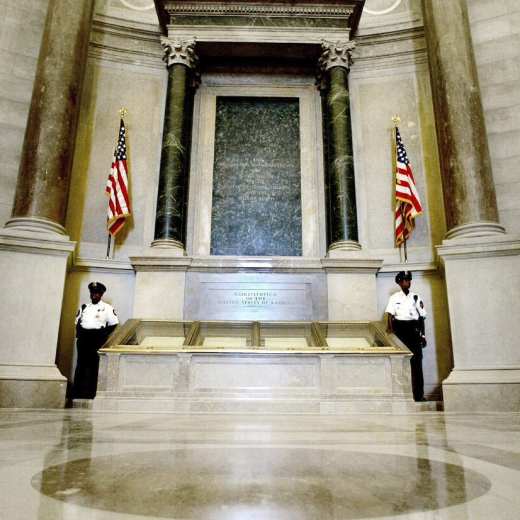 Protesters pour red powder on US Constitution enclosure, prompting evacuation of National Archives