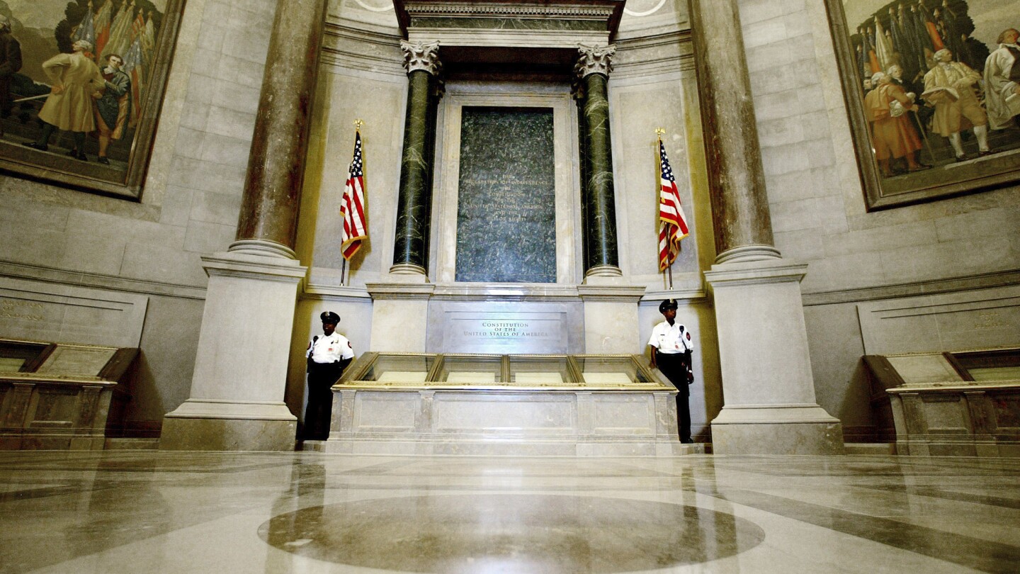 Protesters pour red powder on US Constitution enclosure, prompting evacuation of National Archives