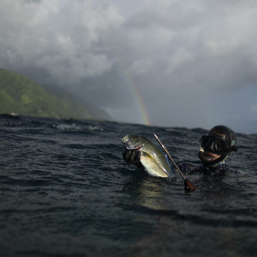 AP PHOTOS: In Teahupo’o, Tahiti, coastal village life thrives among powerful waves