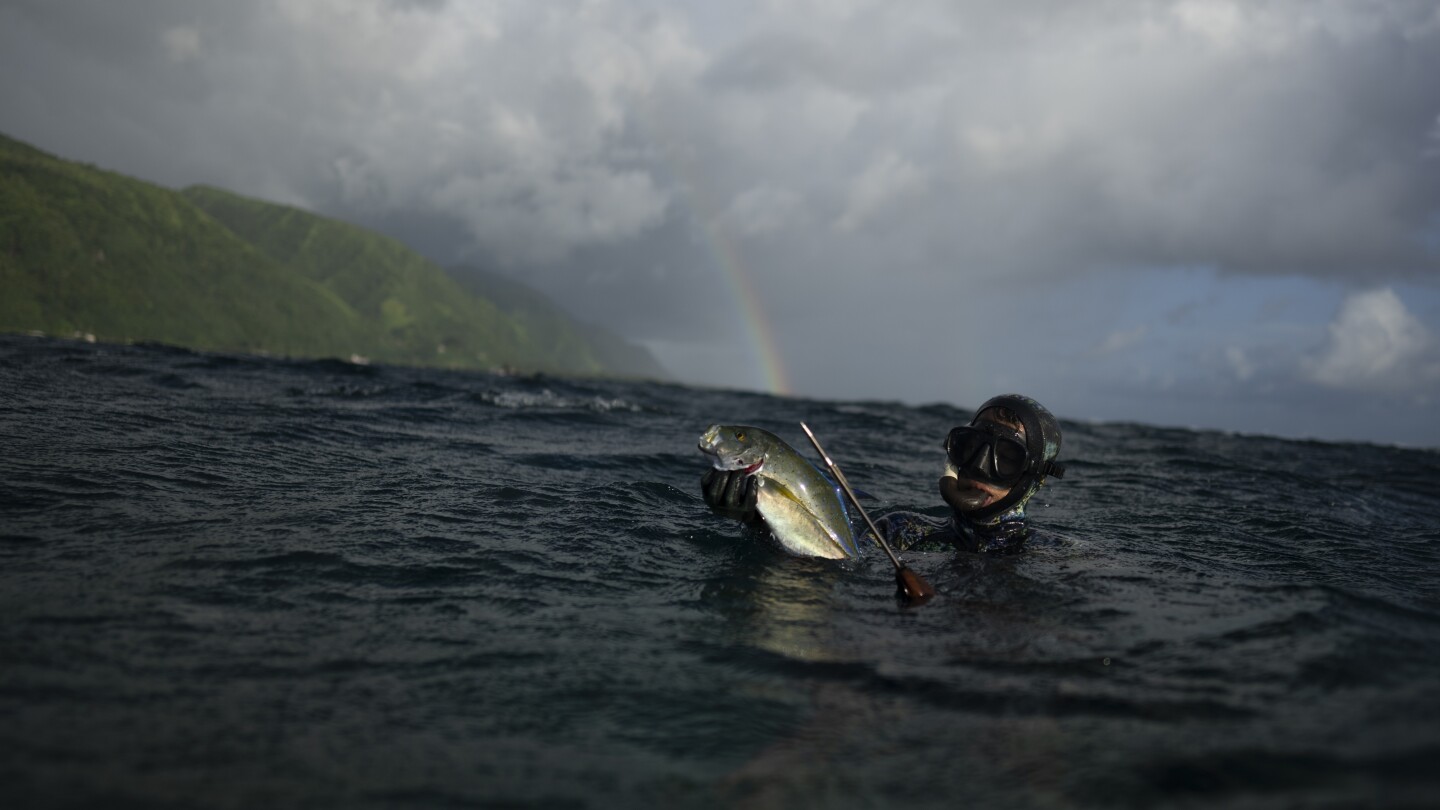 AP PHOTOS: In Teahupo’o, Tahiti, coastal village life thrives among powerful waves