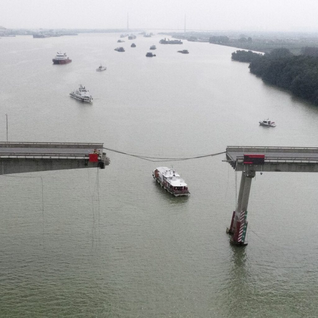 Container ship hits bridge in south China, killing 2 and knocking section of roadway into the water