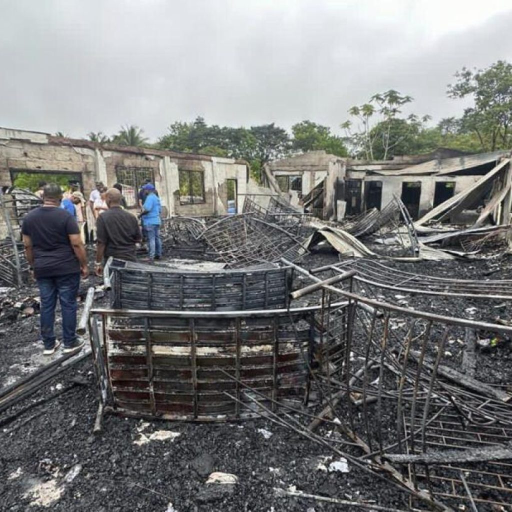 Parents of two girls who survived a dorm fire that killed 20 in Guyana sue the government