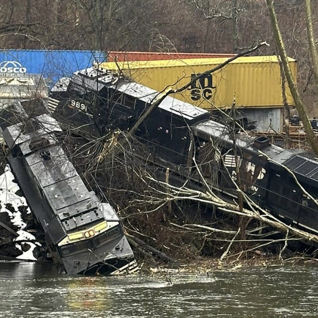 Train derailment leaves cars on riverbank or in water; no injuries, hazardous materials reported