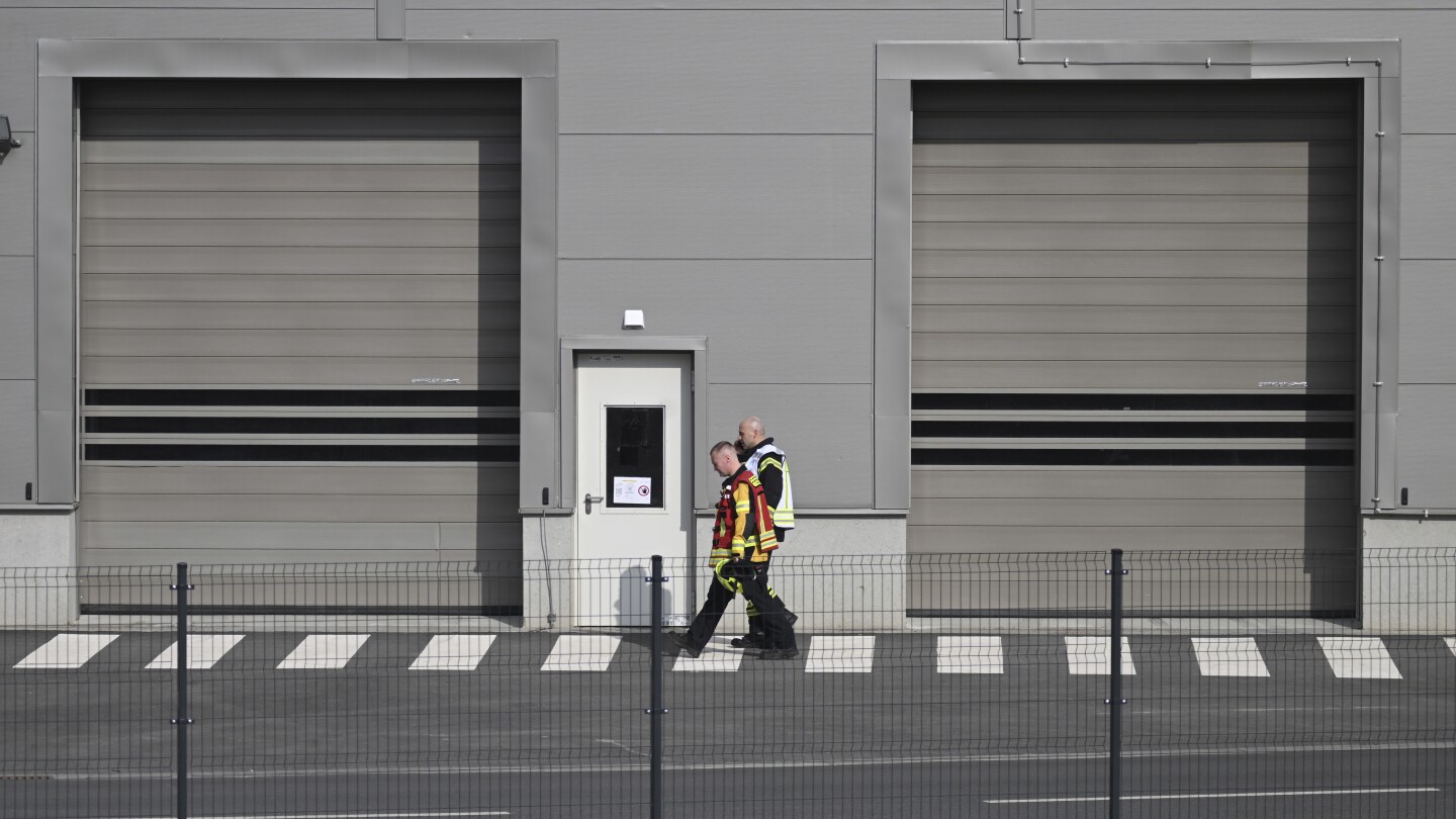 Production at a Tesla plant near Berlin is halted after a power outage. Officials suspect arson