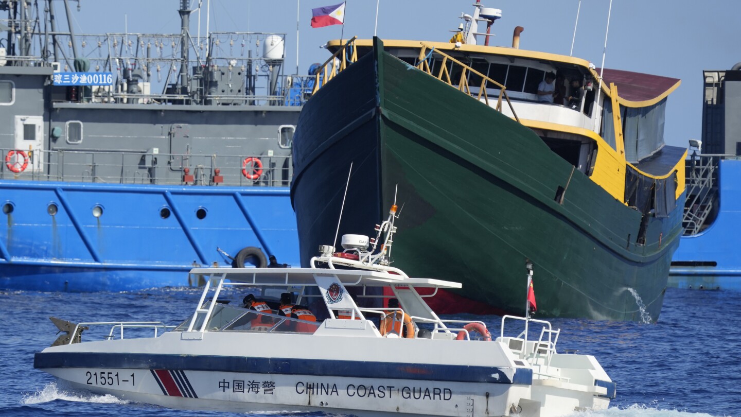 The Philippines says it won’t let China remove a Filipino military outpost on a disputed shoal