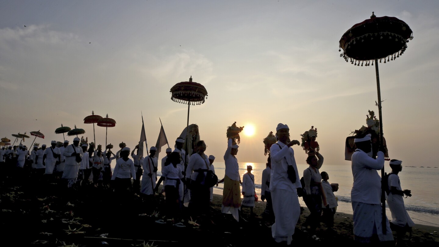 AP PHOTOS: Balinese celebrate New Year with firefights, sword-piercing and a sacred Day of Silence