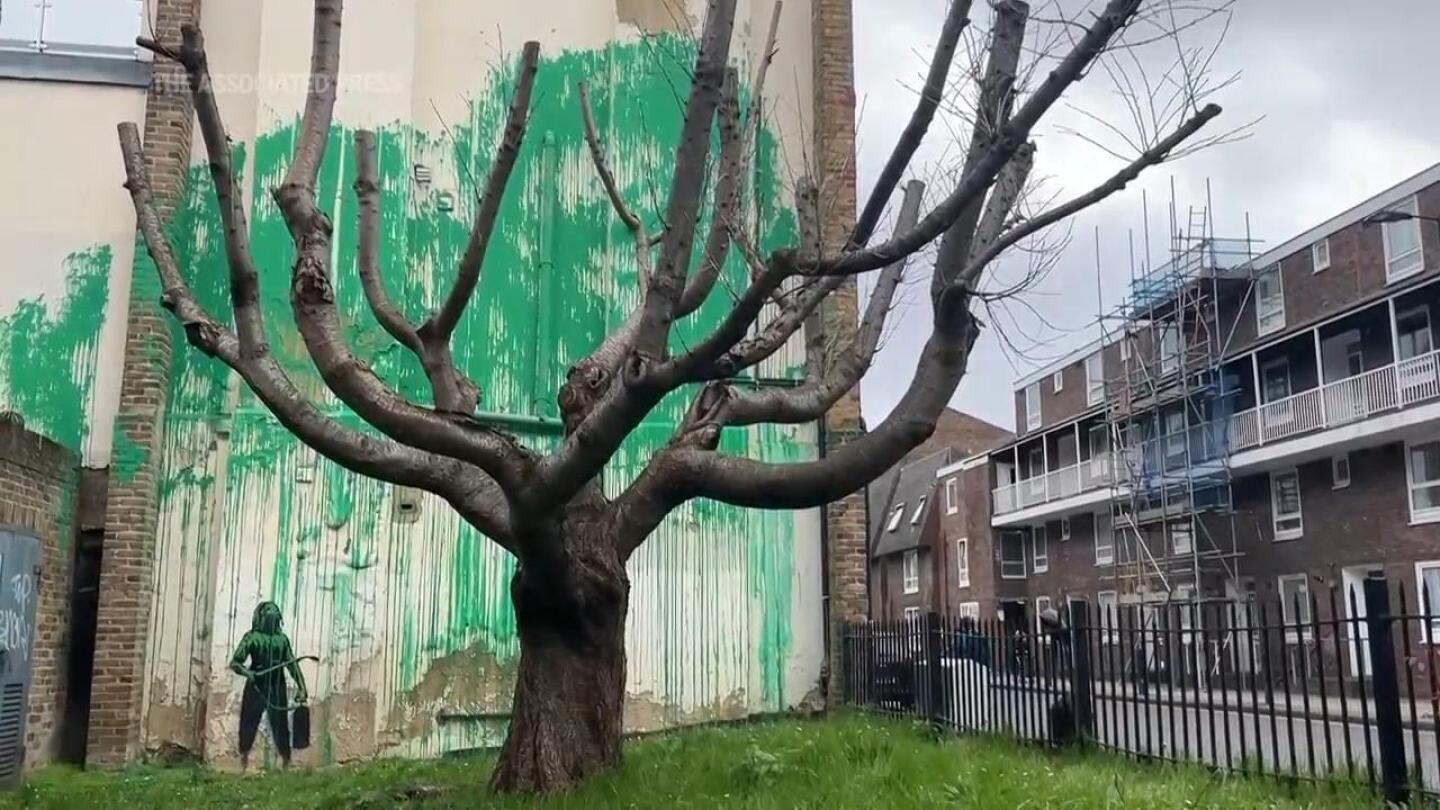 Banksy claims a tree mural on side of building in north London | AP News