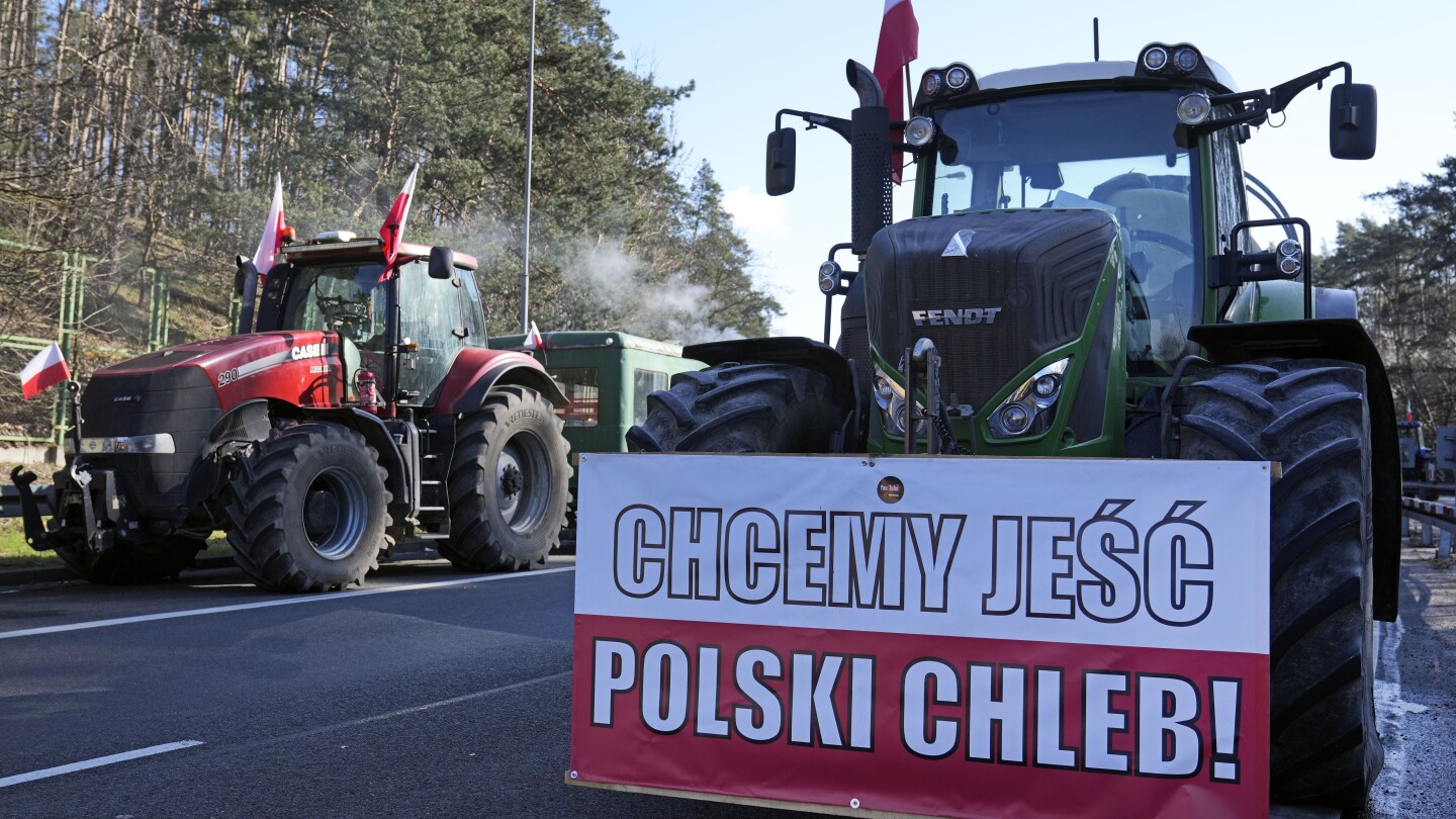 With unsold grain piled high, a Polish farmer faces an uncertain future as war in Ukraine grinds on