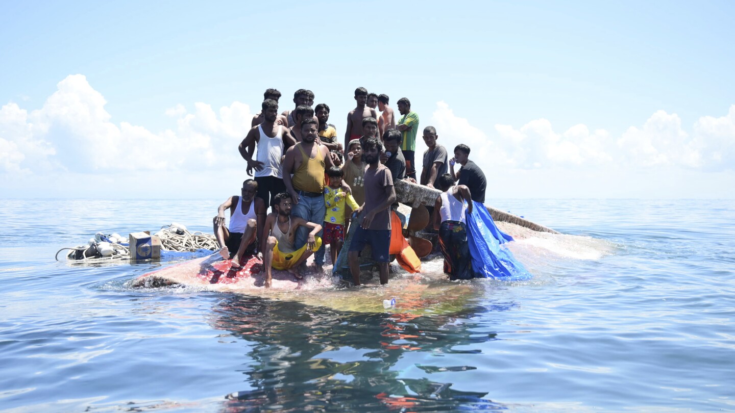 Weeping, weak and soaked, dozens of Rohingya refugees rescued after night on hull of capsized boat