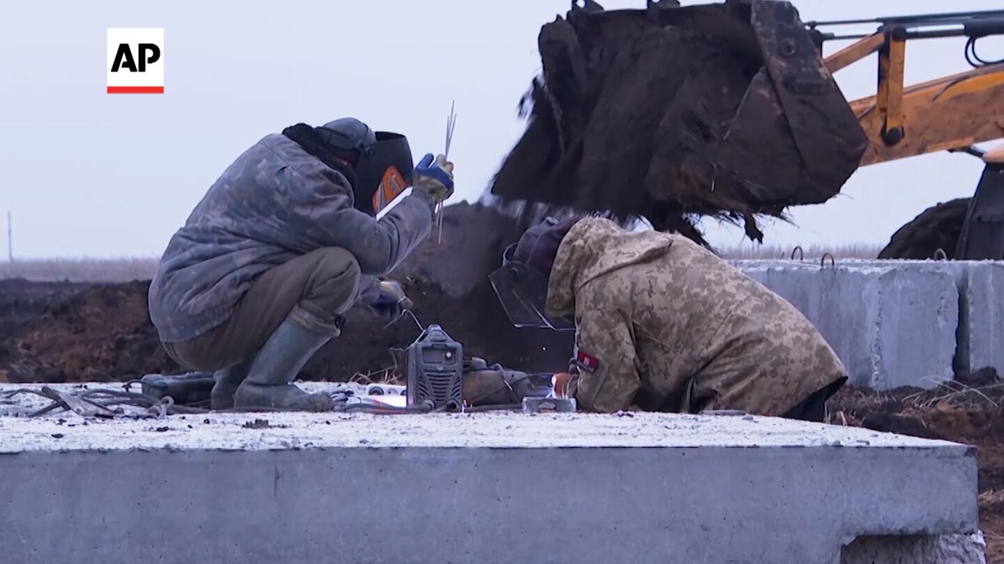 Ukrainians are digging trenches as part of defense in Kharkiv | AP News