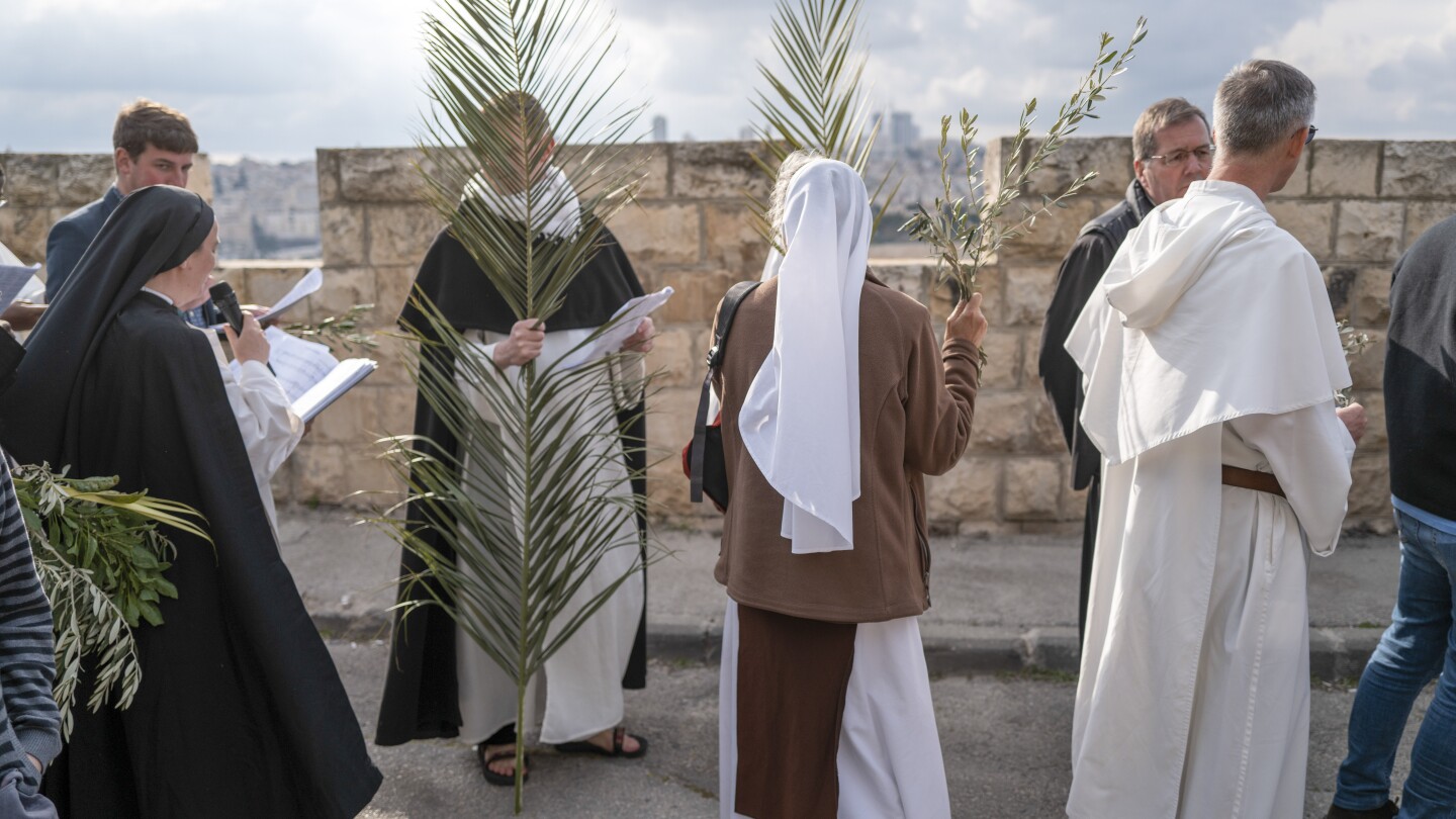 Thousands of faithful attend Palm Sunday celebrations in Jerusalem against a backdrop of war