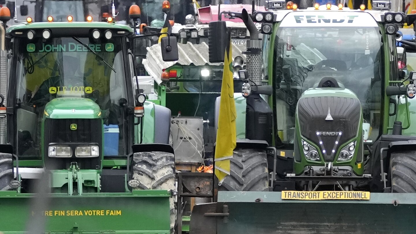 With blaring horns rumbling engines, farmers in tractors block Brussels to protest EU policies