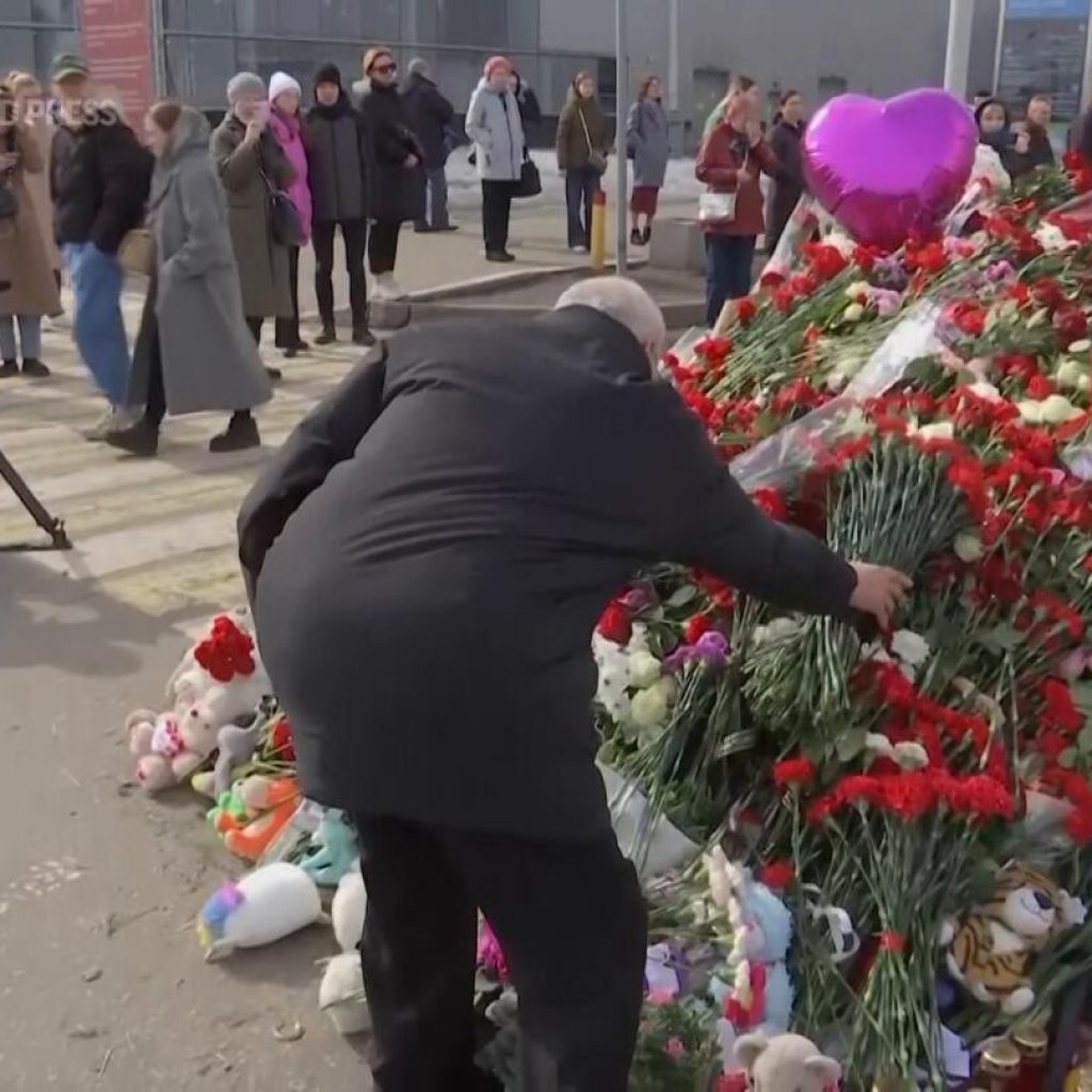 People continue to place flowers at memorial to victims of Russia concert hall attack | AP News
