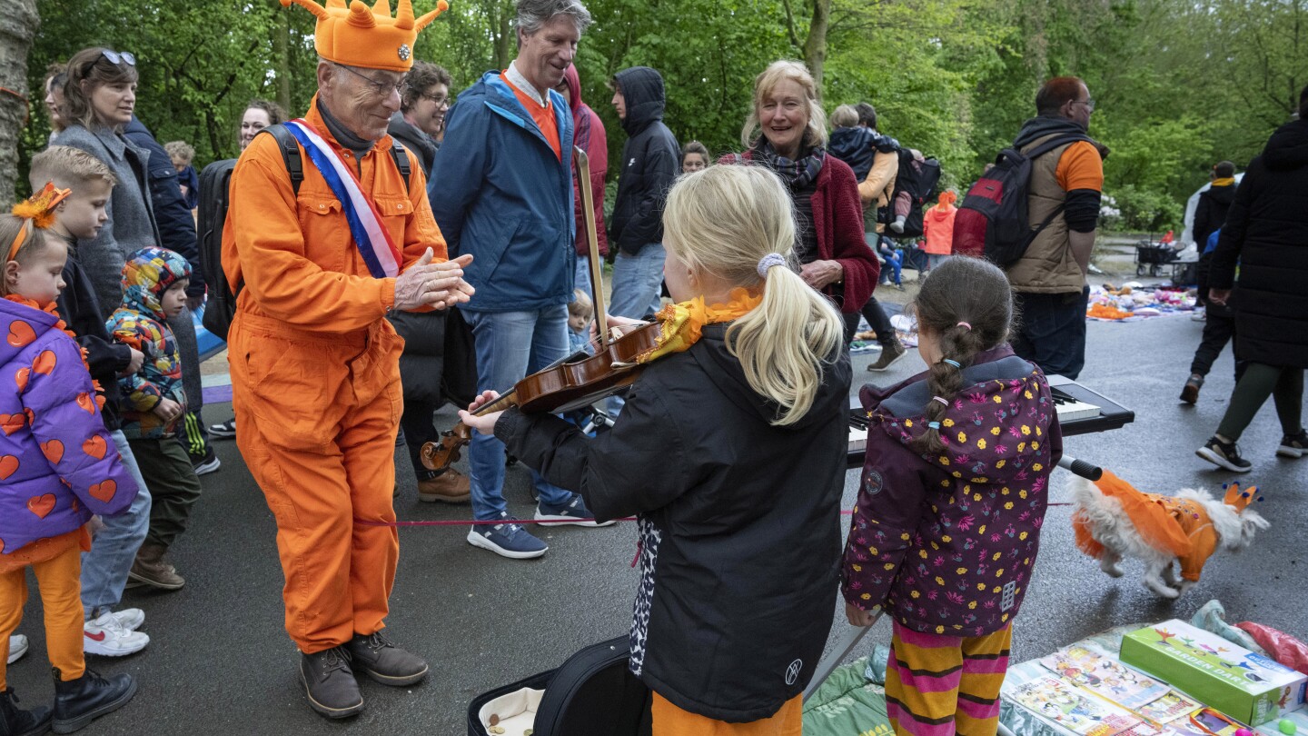 Orange crush: Boats packed with revelers tour Amsterdam canals to celebrate the king’s birthday