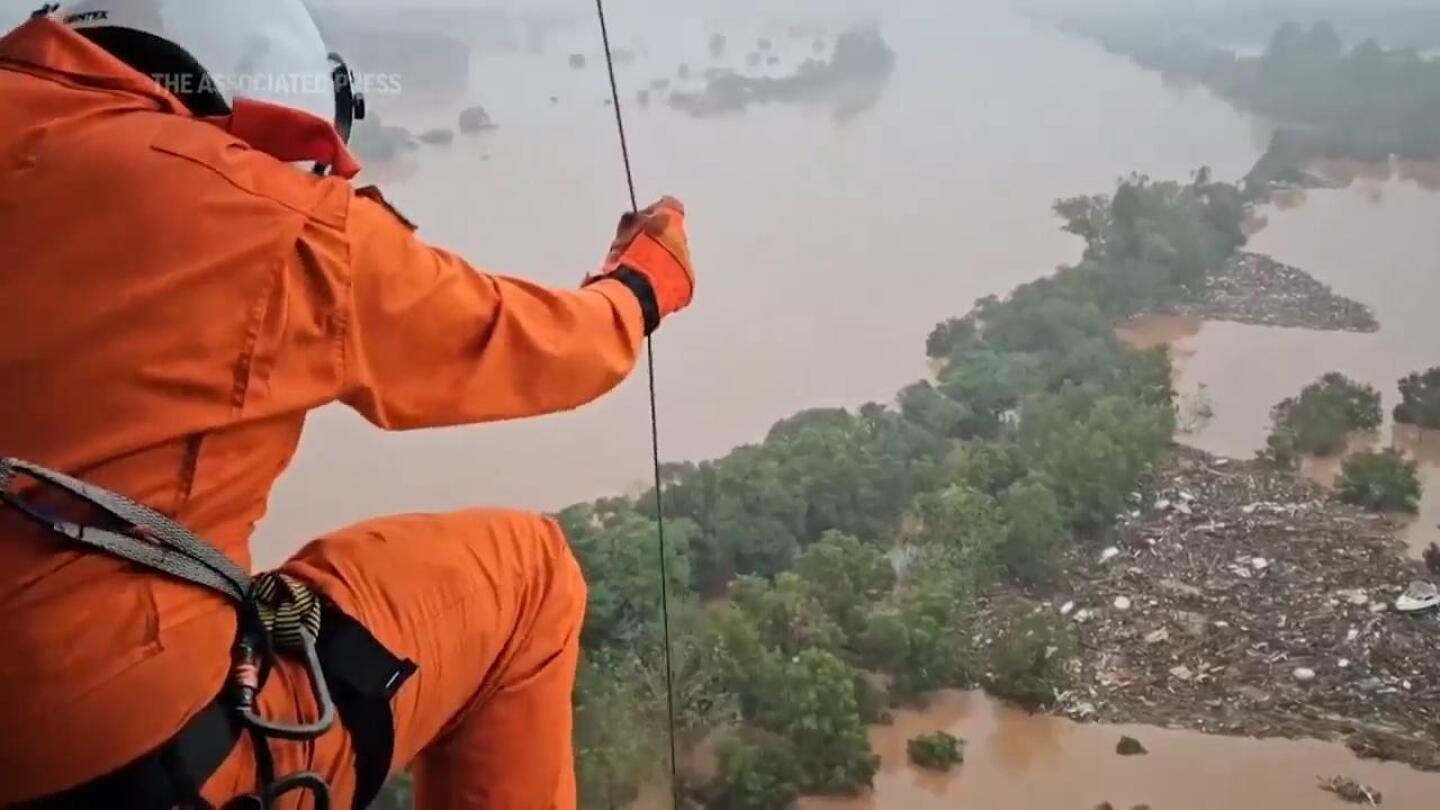 People rescued from rooftops in flood-stricken Brazilian state