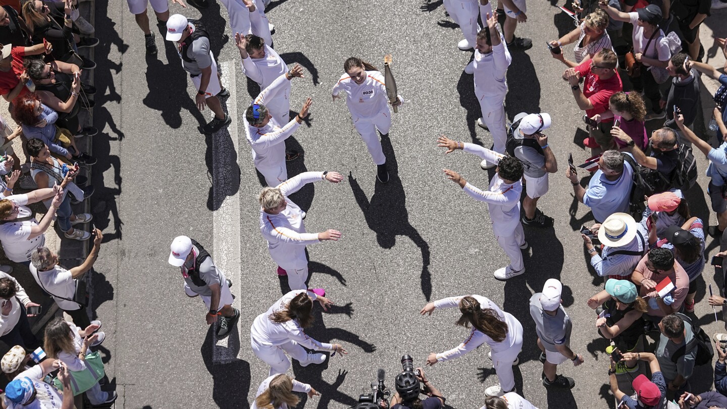 A Ukrainian gymnast carried the Paris Olympic torch with an EU team, in a sign of support