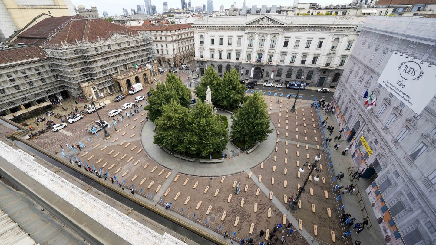 Mock coffins fill a square in Milan in a protest over workplace safety in Italy