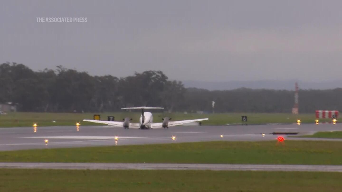 Plane lands safely without landing gear after circling Australian airport for hours to burn off fuel | AP News