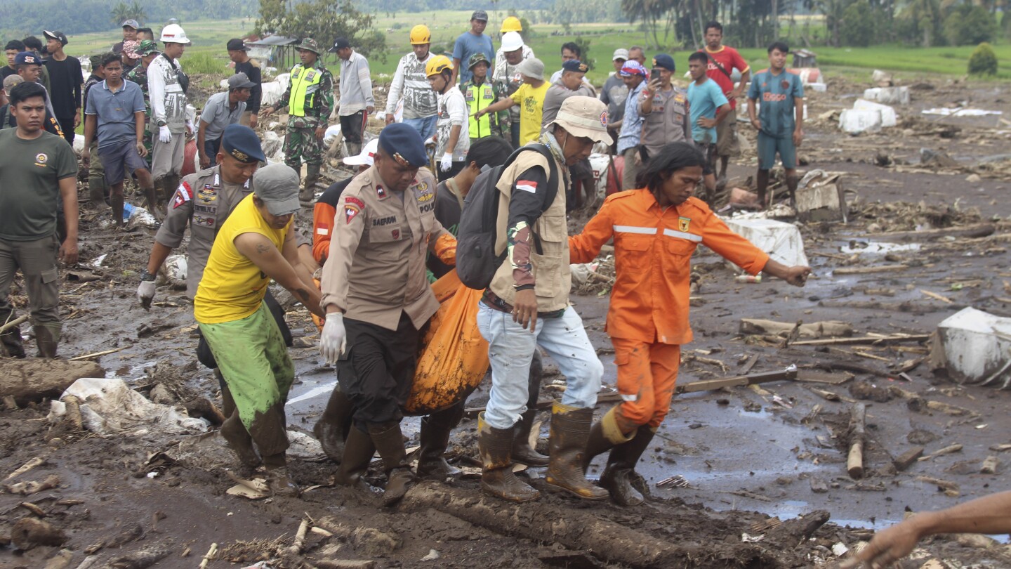 Indonesian rescuers search through rivers and rubble after flash floods that killed at least 50