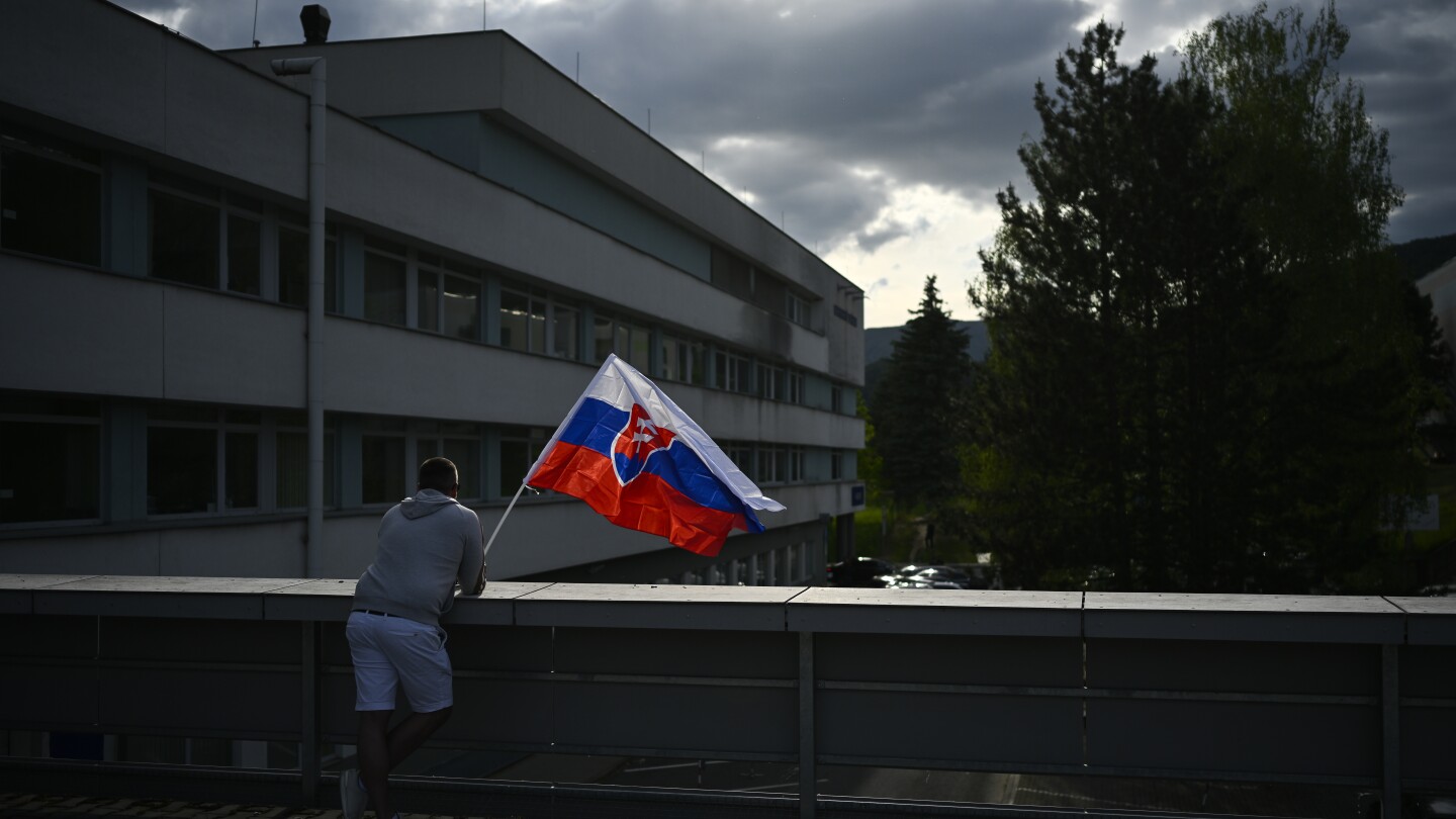 Suspect in shooting of Slovak prime minister is escorted to his home as police search for evidence