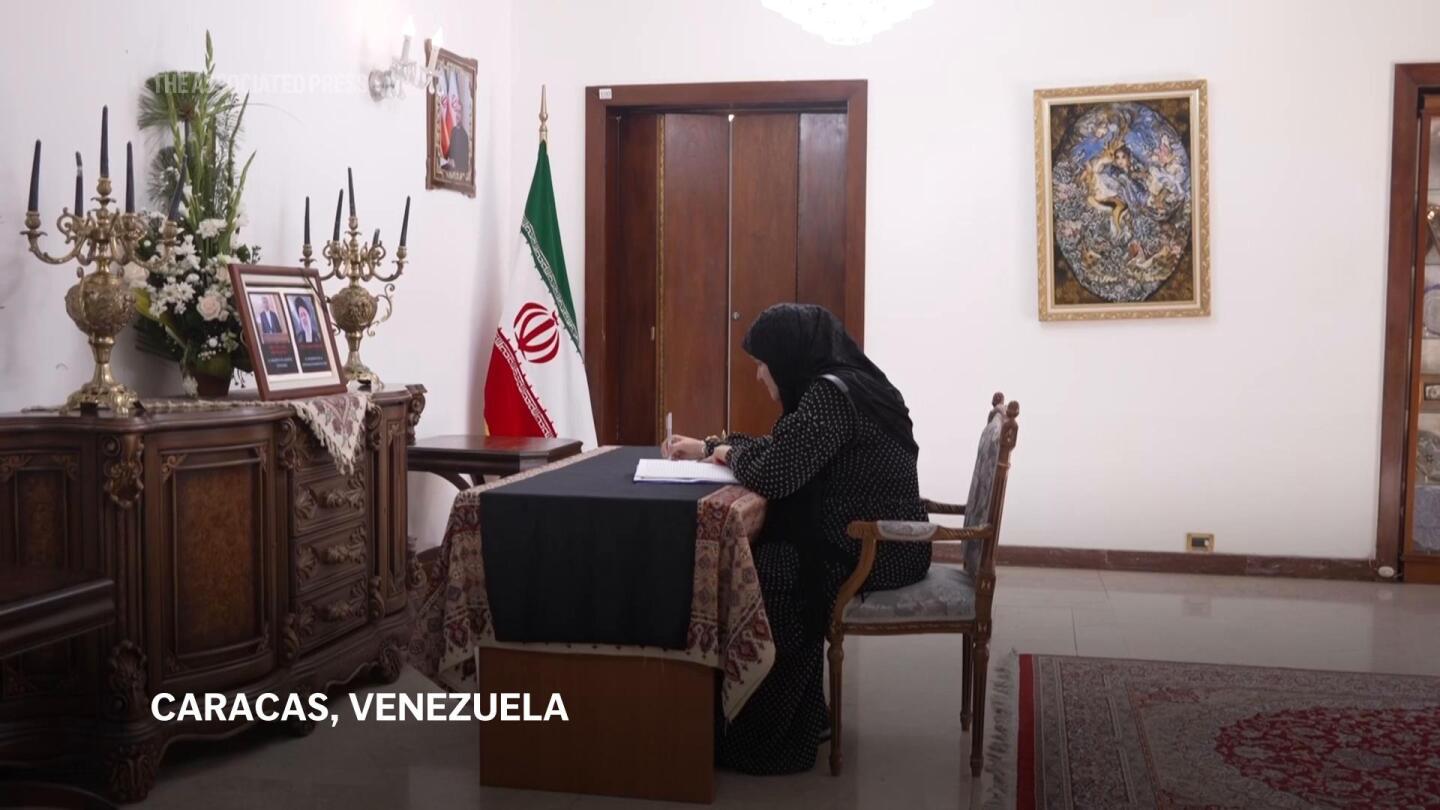 Venezuelans pay tribute to late president Raisi at Iranian embassy | AP News