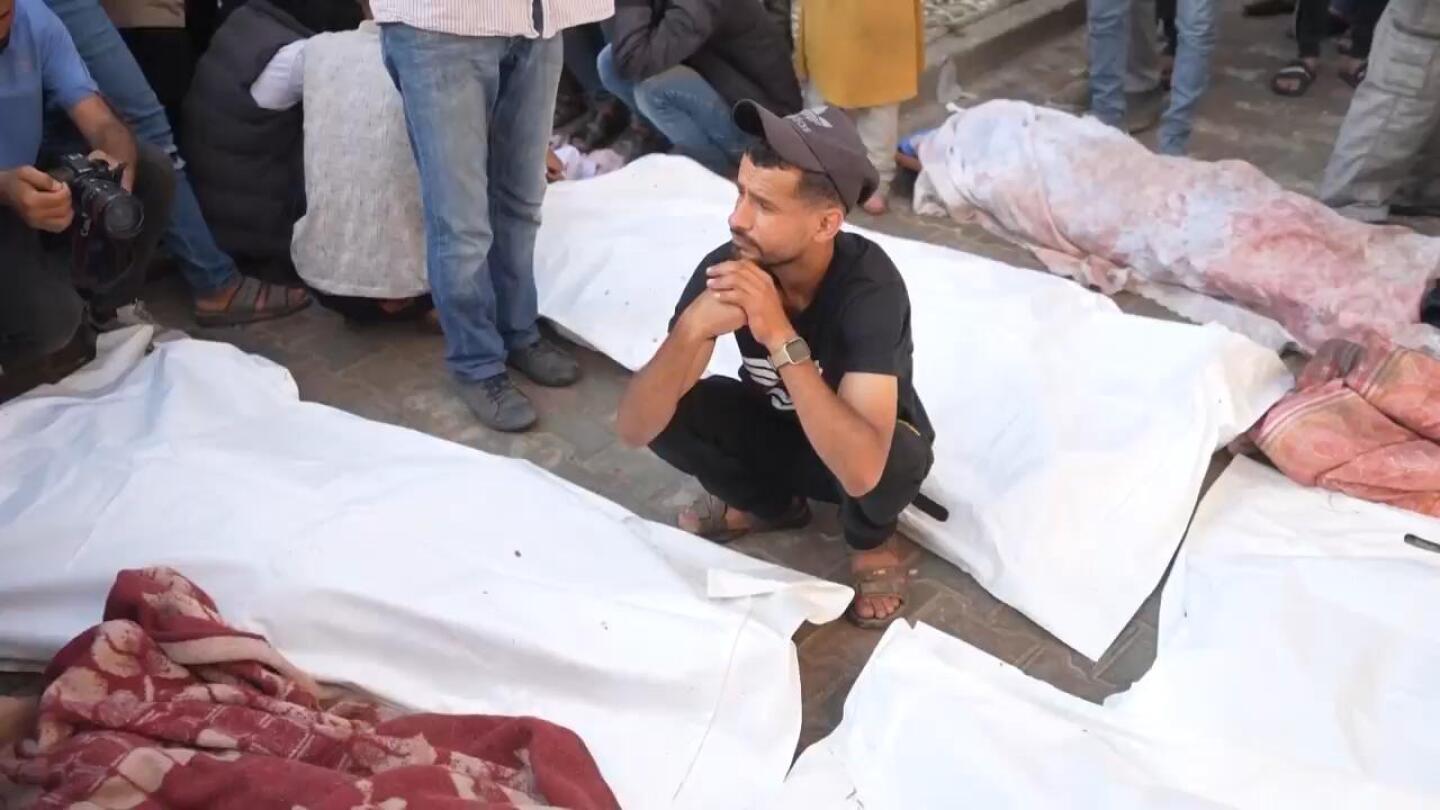 People mourn victims of Israeli bombardments across central Gaza which killed at least 48 people | AP News