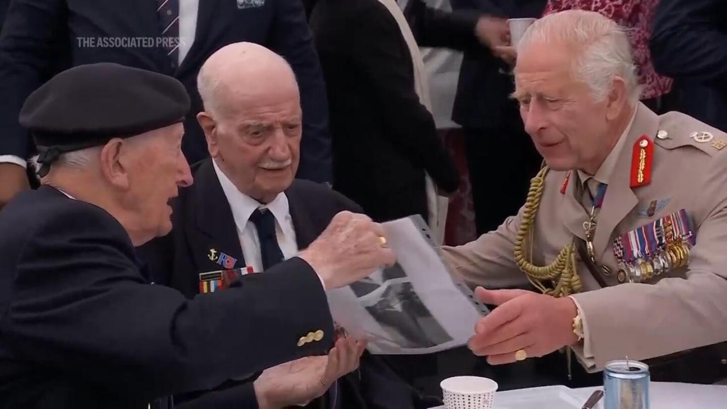 Veterans mingle with King Charles III and Queen Camilla following UK D-Day memorial in Normandy | AP News