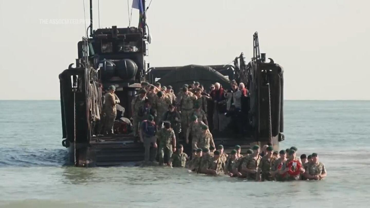 British soldiers, piper, mark 80th anniversary of D-Day with re-enactment on Normandy beach | AP News