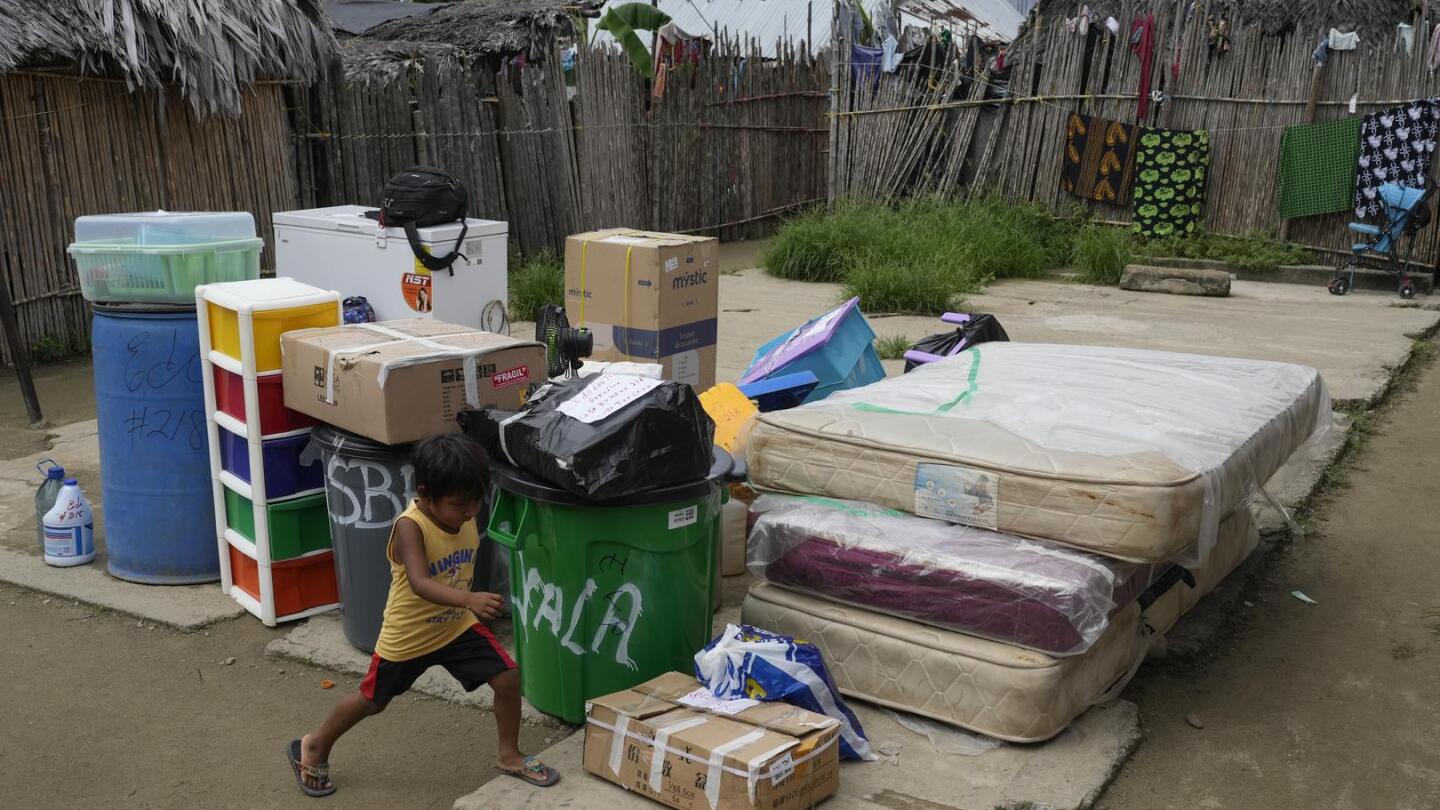Panama community forced from Caribbean island by rising sea levels move into new homes | AP News
