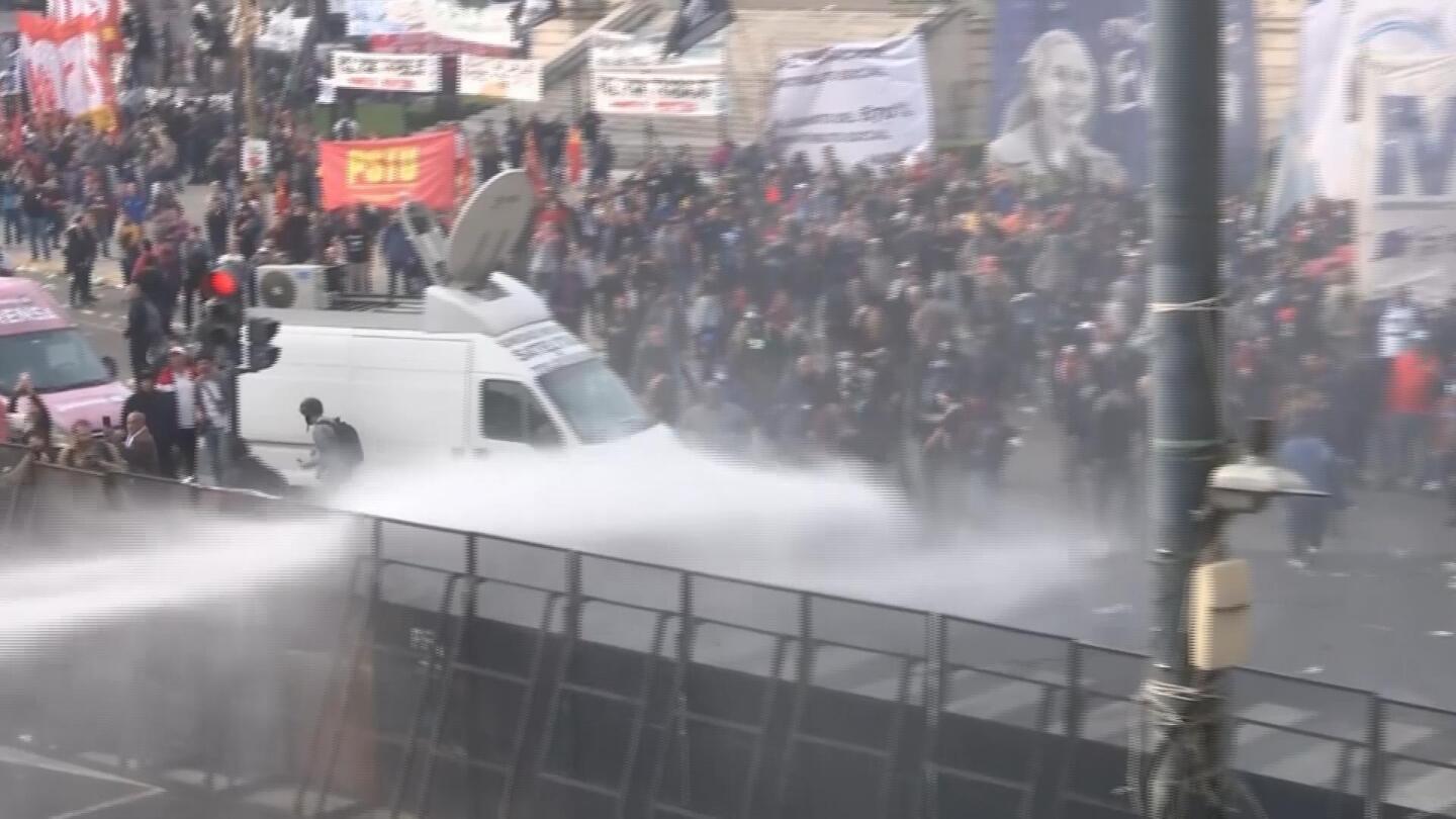 Water cannon used on protesters outside Argentina Senate as vote held on state overhaul, tax bills | AP News