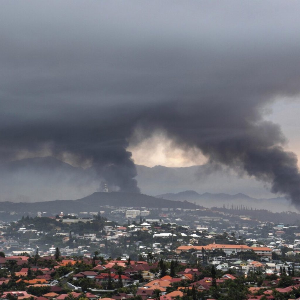 New Caledonia reopening its international airport and shortening curfew as unrest continues to ebb