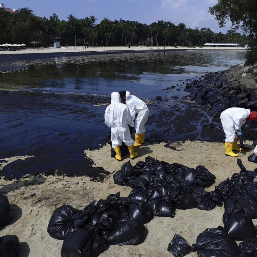 Singapore says dredger that hit tanker reported sudden loss of control, oil spill cleanup ongoing