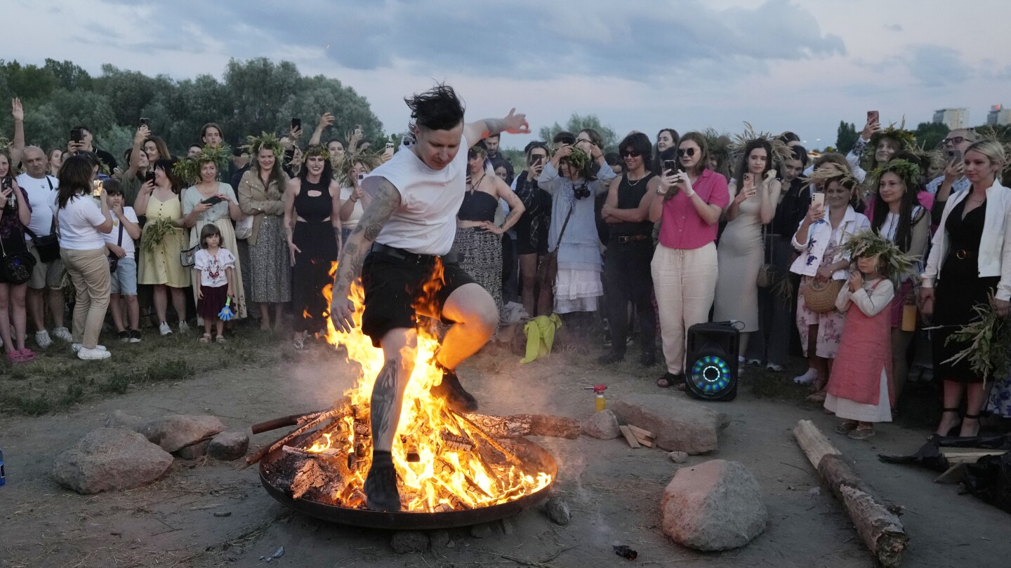 Ukrainians in Warsaw jump over a bonfire, float braids to celebrate solstice custom away from home