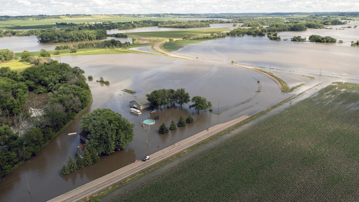 Millions in the US prepare for more sweltering heat as floodwaters inundate parts of the Midwest