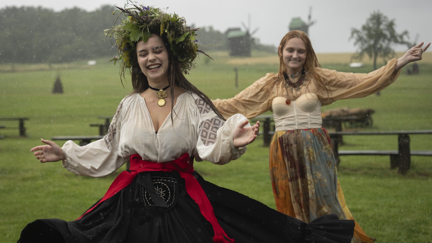 Under curfew, Ukrainians mark midsummer with bonfire jumping at a festival with pagan roots