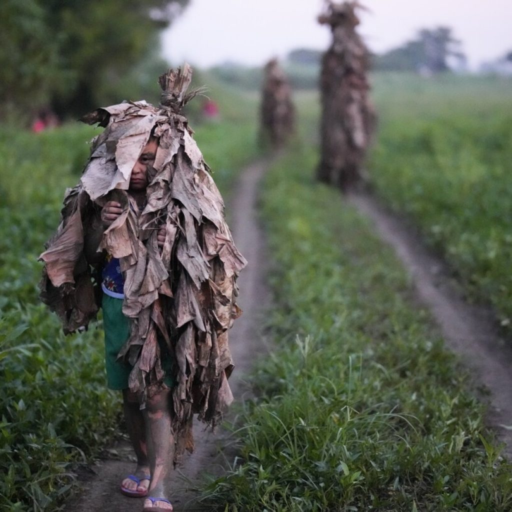 An AP Photographer picked his own path when trying to make the perfect Mud People Festival photo