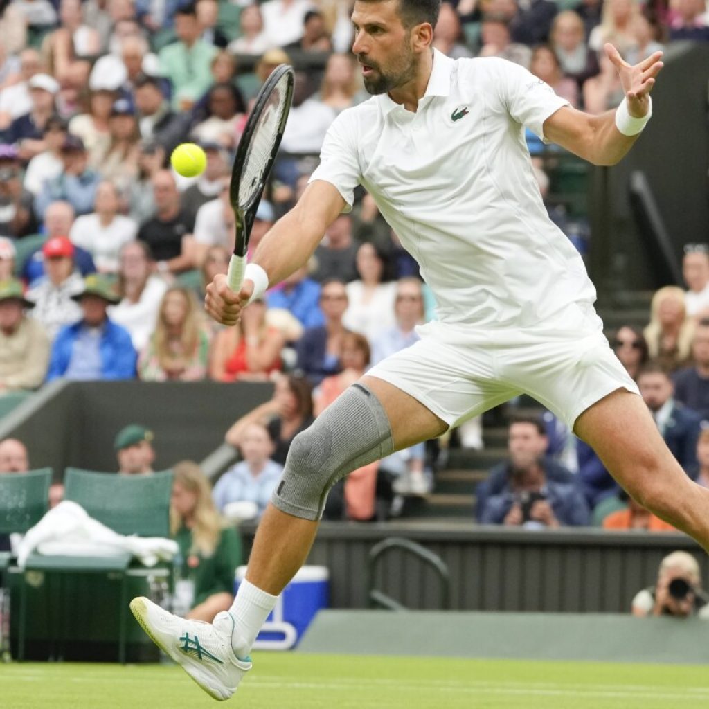 Novak Djokovic wins his first match at Wimbledon with a sleeve on his surgically repaired knee